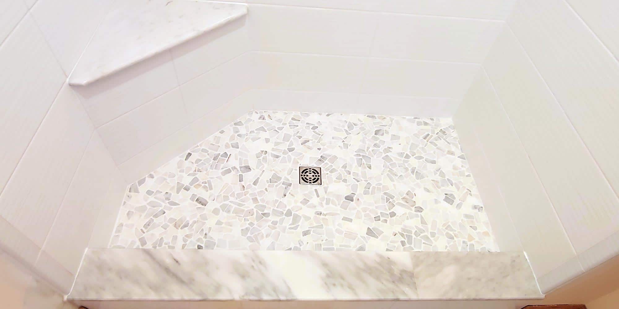 tumbled marble river rock on the floor of shower